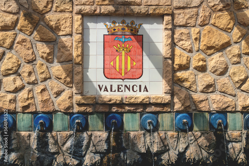 Water fountains with a flag emblem of Valencia in the village of Polop de Marina, Costa Blanca, Spain