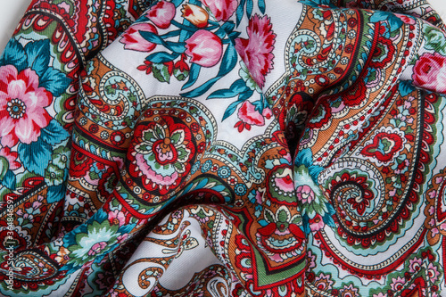 horizontal view closeup on crumpled white cotton scarf with paisley floral ornament © alkiona_25