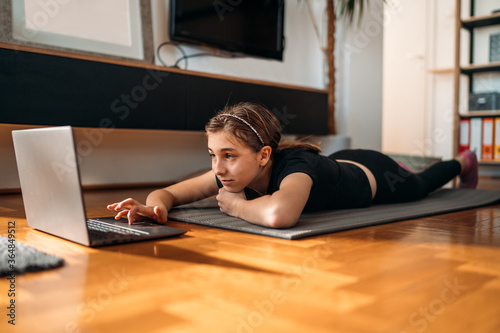 Girl watching exercise tutorials online
