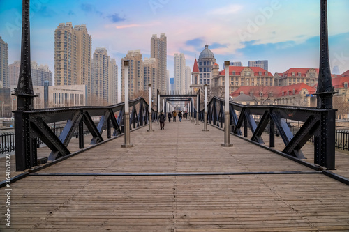 Tianjin, China - Jan 16 2020: Tianjin pedestrian wooden bridge over Haihe river in Nankai district