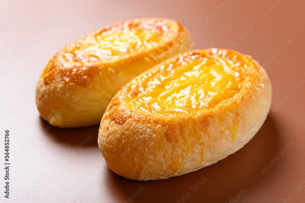 side view two pieces egg yolk flavor bread on brown background side view two pieces egg yolk flavor bread on brown background