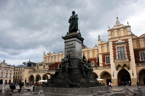 Polish Pole people and foreign travelers travel visit Adam Mickiewicz Monument and shopping in Cloth Hall Sukiennice Krakow Old Town Main Square at Stare Miasto on September 20, 2019 in Lesser, Poland
