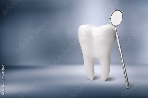 Human s white tooth and dentist mirror