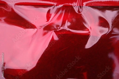 Crumpled red plastic texture.