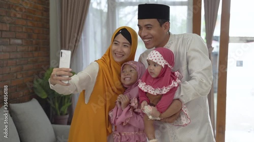 family talking on the phone congratulate each other on eid mubarak celebration at home using video calling photo