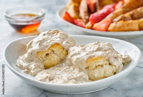biscuits and gravy with sausage on plate photo