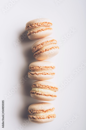 Tasty macaroons on table background, homemade food. Top view