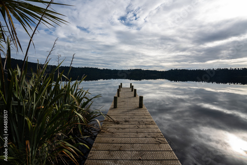 Clouds and reflections at Lake Ianthe on the West Coast of New Zealand photo