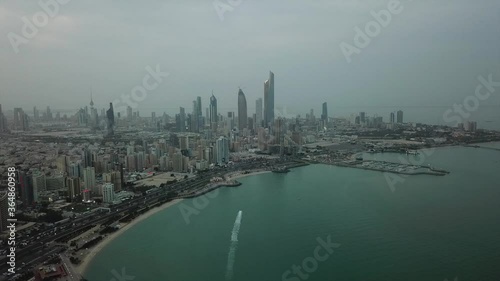 Wide panoramic view of Kuwait City facing the Arabian / Persian Gulf at dusk.
