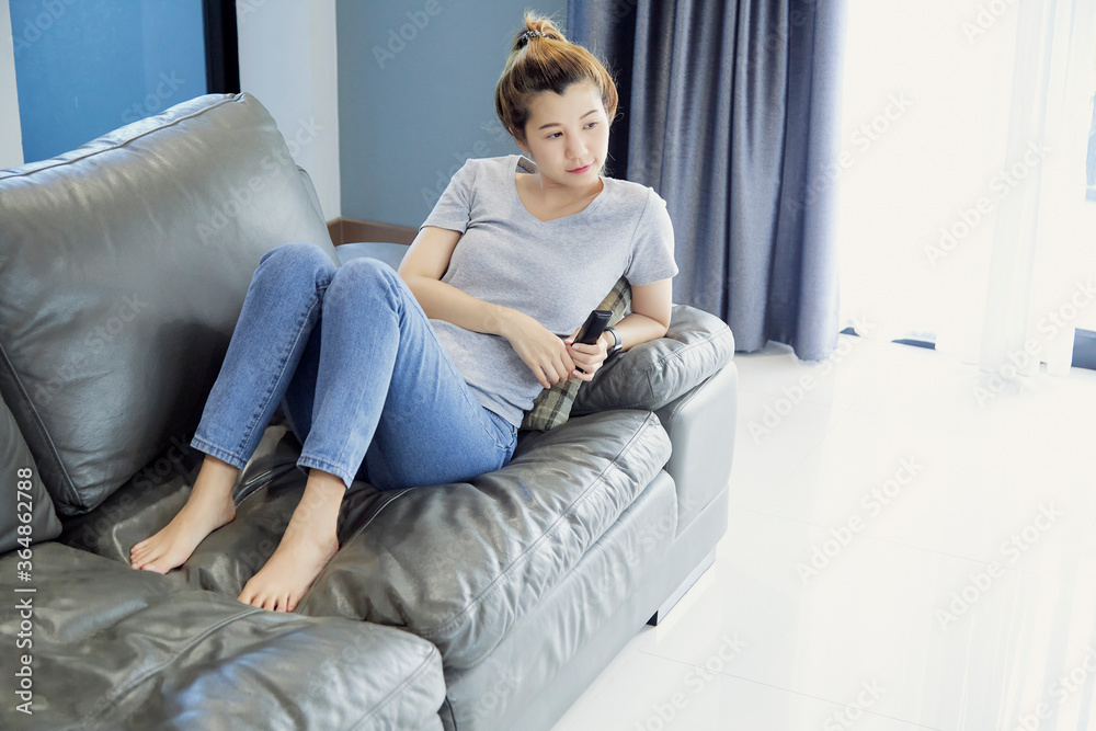 Fototapeta premium woman relaxing on sofa at home in the living room