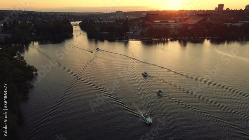 Aerial View of Boats Traveling by University of Washington Stadium in Golden Hour Lighting photo