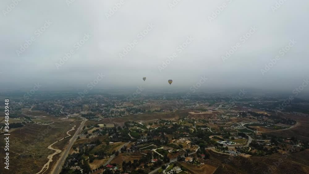 Hot Air Balloons in flight above Temecula, California. Far distant with panoramic city view. Misty Morning. 43 sec. Hot Air Balloons in flight above Temecula, California. Far distant with panoramic city view. Misty Morning. 43 sec.