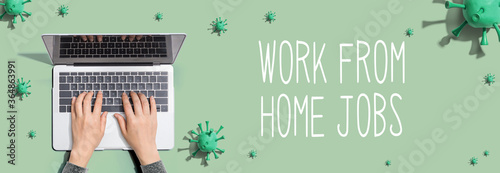 Work from home jobs theme with person using a laptop computer