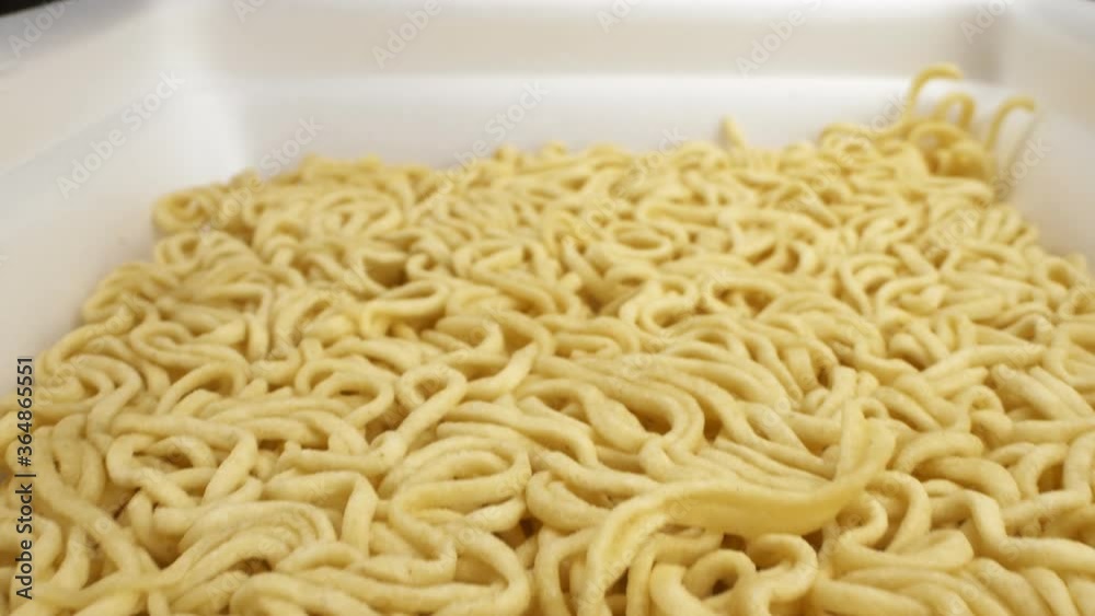 super close up. the details. seasoning powder sprinkles on dry instant noodles