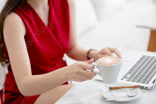 young business woman with mug in hands drinking coffee in the morning at restaurant