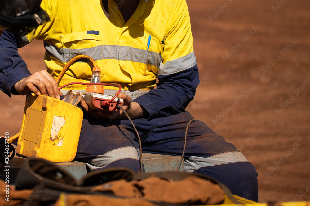 Safety workplace trained competent electrician setting holding