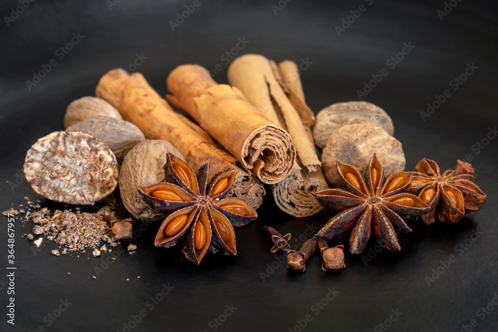 Mix of Spices Cinnamon Nutmeg Star Anise and Cloves on Slate