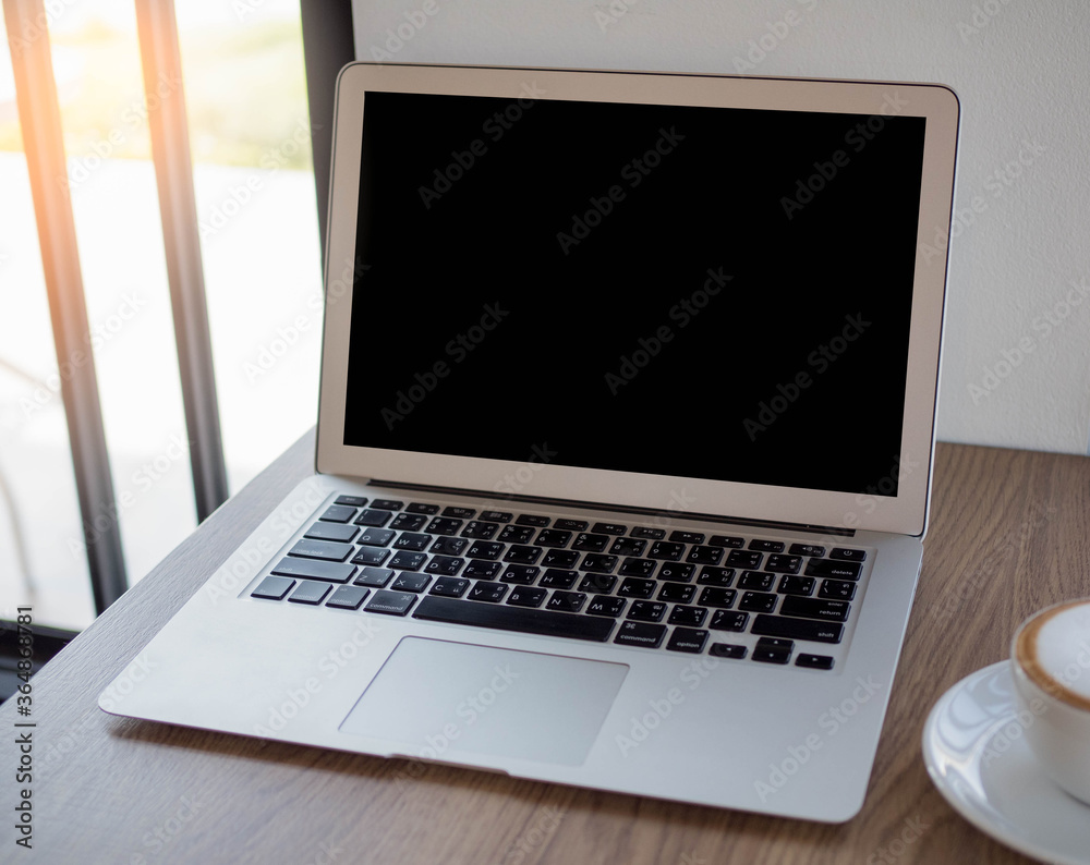 laptop on table with cup of coffee in home. laptop on table with cup of coffee in home.