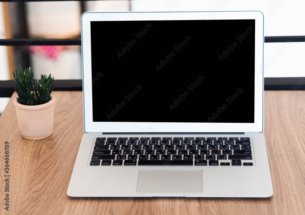 laptop with blank screen on table in cafe. laptop with blank screen on table in cafe.