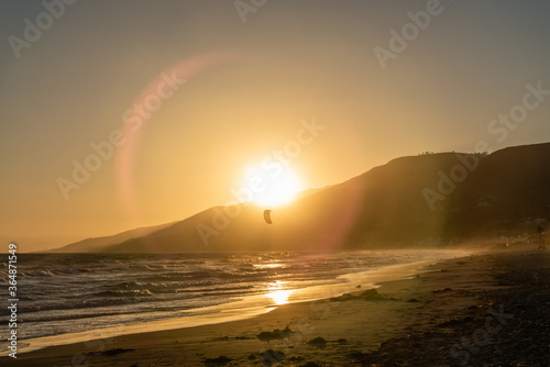 Fotografie Kite surfing at sunset at Zuma beach, Malibu, Southern California