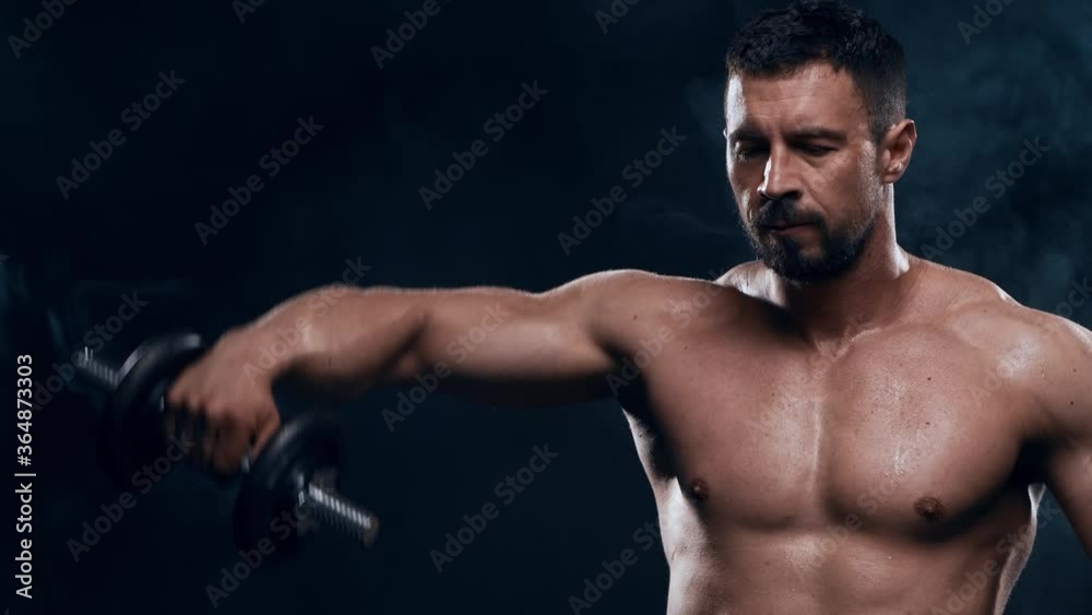 Fit and sporty bodybuilder over black background. Bodybuilder training using dumbbells. Sport and fitness. Fit and sporty bodybuilder over black background. Bodybuilder training using dumbbells. Sport and fitness.