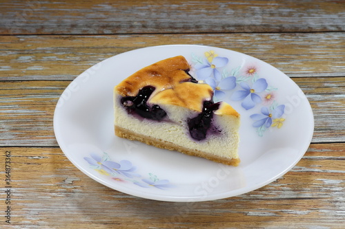 Piece of blueberry cheesecake on the plate. Luxury and famous baked menu in coffee shop and bakery shop.  photo