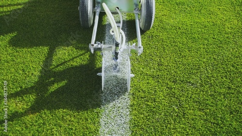 Marking football stadium field using a professional paint machine