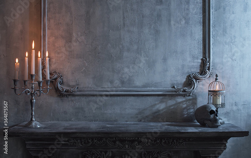Mystical Halloween still-life background. Skull, candlestick with candles, old fireplace. Horror and witchery.