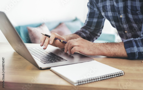 Male student studying online using laptop. Online education concept photo