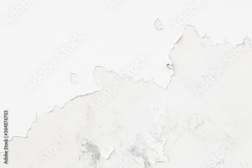 Peeling paint on old grunge white dirty concrete wall texture abstract background