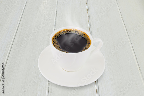 White coffee cup on white vintage wooden tabletop background