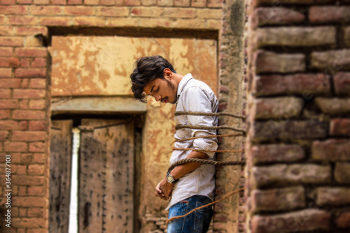young man leaning against brick wall © BALLJINDER