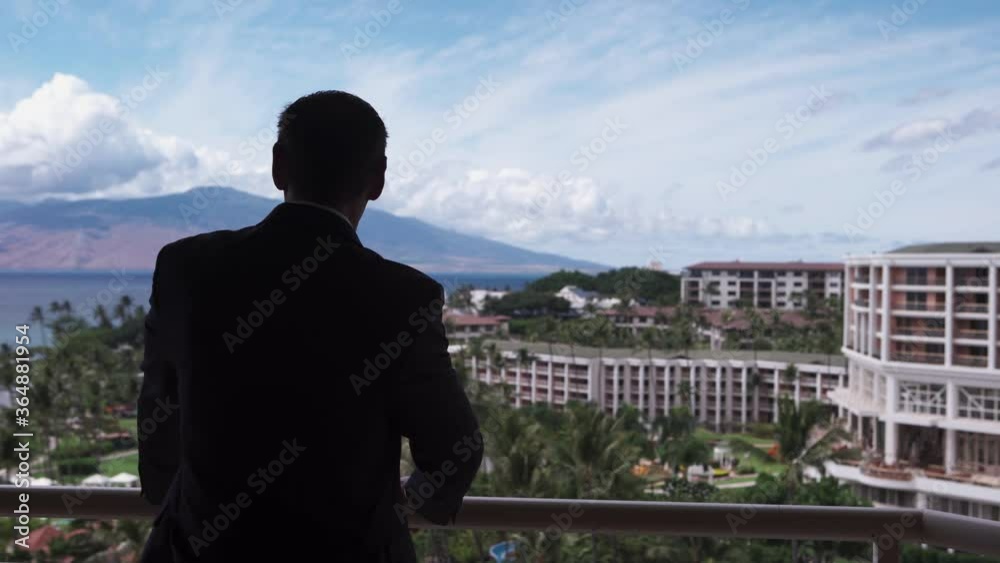 Businessman stares at luxurious hotel coastline in Maui Hawaii. Businessman stares at luxurious hotel coastline in Maui Hawaii.