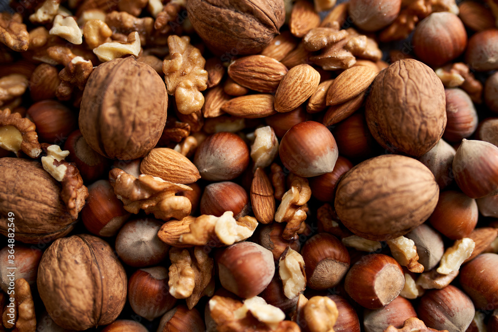 Mix of different nuts, background wiith walnuts, almonds and hazenuts Mix of different nuts, background wiith walnuts, almonds and hazenuts
