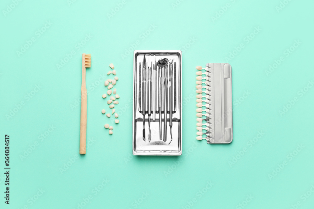 Dental tools with toothbrush and teeth samples on color background