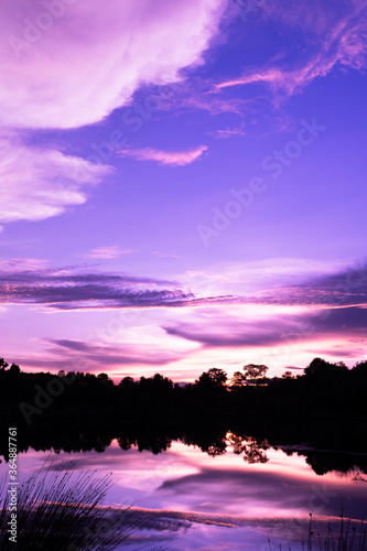 cloud purple dramatic sunset sky reflection on water lake scenery nature background