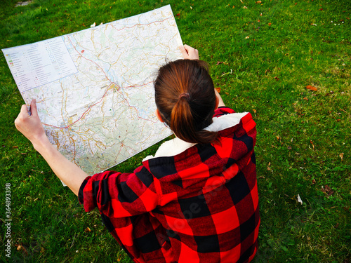 young woman reading a map