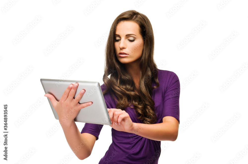 Portrait of a beautiful woman holding tablet computer isolated on a white background. Looking at tablet. Portrait of a beautiful woman holding tablet computer isolated on a white background. Looking at tablet.