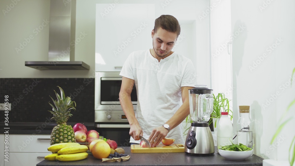 Man is Squeezing the juice from grapefruit to blender to make the smoothie Man is Squeezing the juice from grapefruit to blender to make the smoothie
