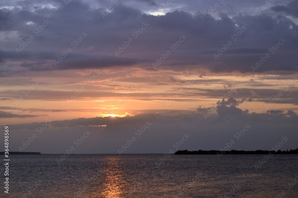 Dramatic background of the sunset with orange sky and sea.