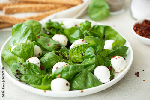 small mozzarella balls with basil and balsamic vinegar photo