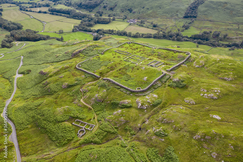 Aerial of Hardknott Roman Fort is an archeological site, the remains of the Roman fort Mediobogdum, located on the western side of the Hardknott Pass in the English county of Cumbria © jmh-photography