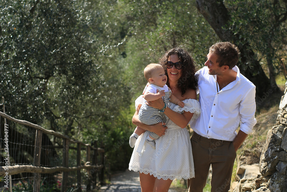 Young beautiful family walks in the Park in Italy
Young beautiful family walks in the Park in Italy