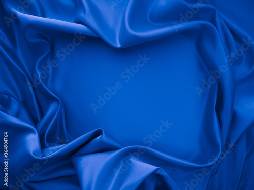 Beautiful elegant wavy classic blue satin silk luxury cloth fabric texture, abstract background design.