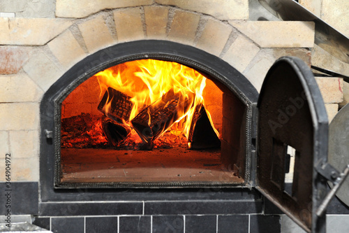 Burning firewood in a pizza oven.