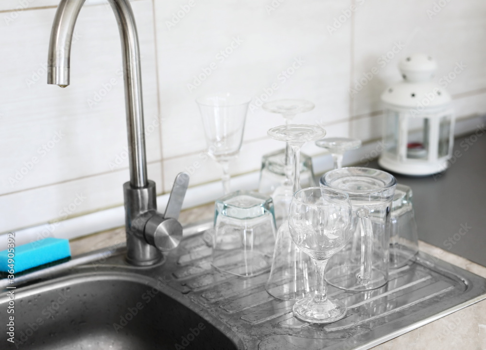 Kitchen counter steel chrome sink, drain with clean glasses Kitchen counter steel chrome sink, drain with clean glasses