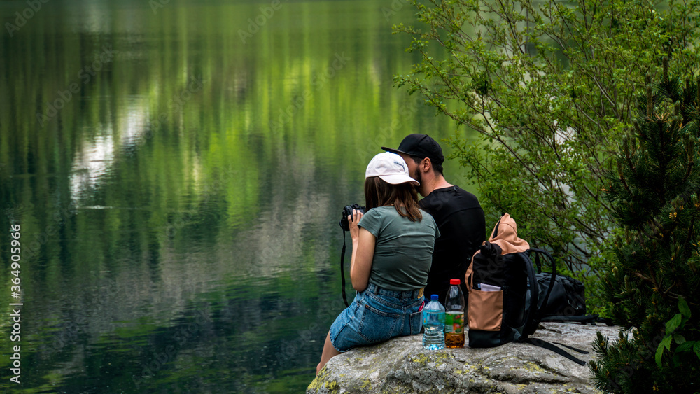 Girl showing boyfriend photos at the pond Girl showing boyfriend photos at the pond