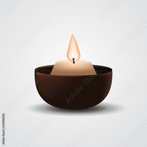 burning candle in holder