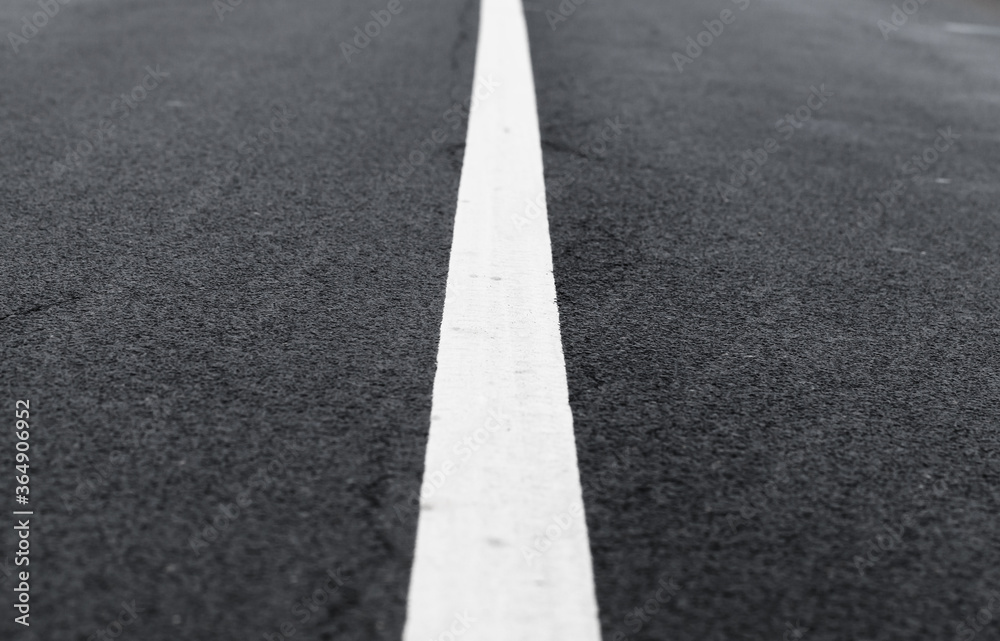 White dividing line perspective over dark asphalt White dividing line perspective over dark asphalt