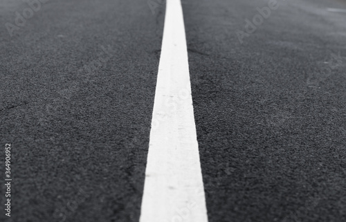 White dividing line perspective over dark asphalt
